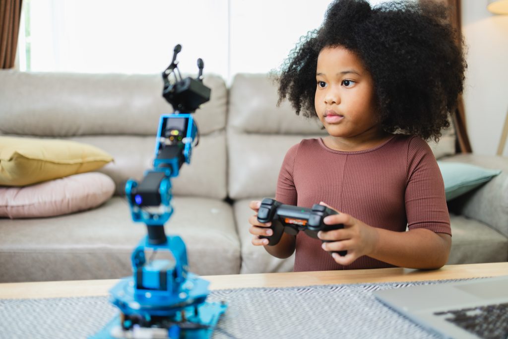 African American girl learning robotic with a program computer.